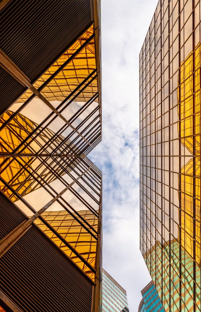 HONG KONG, CHINA - January, 2021 : Golden tall buildings and glass reflections in Hong Kong Island Business concepts of buildings and architecture